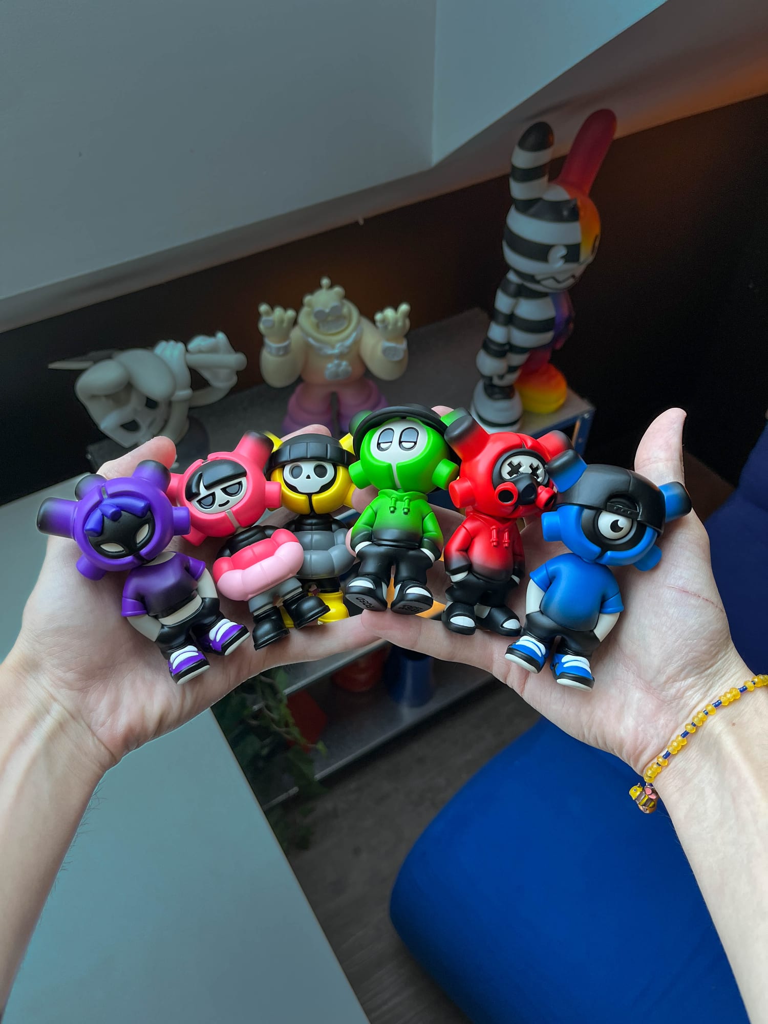 The six EQSO The Crew blind box figures held in two hands: Purple, Cherry, Skully, Supagreen, Vandal and Cyclo