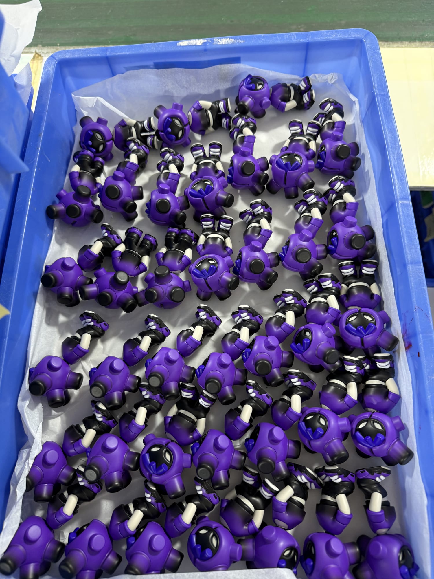 Painted purple heads and bodies of EQSO The Crew figures, before assembly