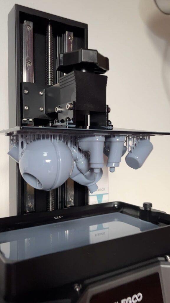 Parts of a prototype 3D-printed in resin, still attached to the printer’s build plate with their supports